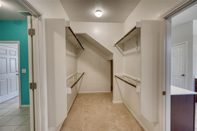 Spacious closet featuring light tile patterned flooring and light carpet | Image 22