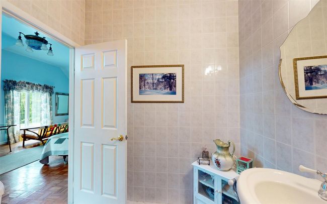 Bathroom featuring tile walls, a sink, and connected bathroom | Image 32