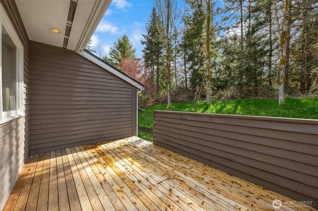 The deck off the primary bedroom makes a great spot to take in the beautiful grounds! | Image 28