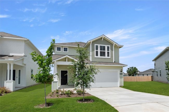 View of front of house with driveway, a garage, and a shingled roof | Image 5