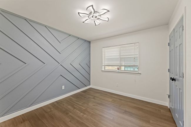 Spare room featuring baseboards and wood finished floors | Image 24
