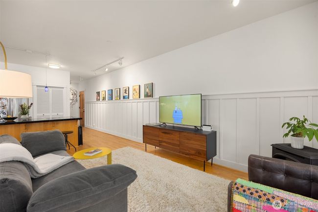View from the balcony back to the kitchen, front door and propane stove on the right. The art wall is lit by directional lighting. | Image 6