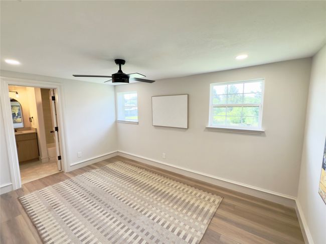 Unfurnished bedroom with light wood-style flooring, recessed lighting, ensuite bath, and ceiling fan | Image 35