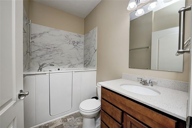 Guest Bathroom with Kohler walk-in tub with heat and jets. Quartz counter tops | Image 23