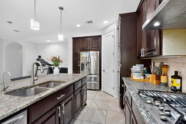 Dining room with light tile patterned floors | Image 11