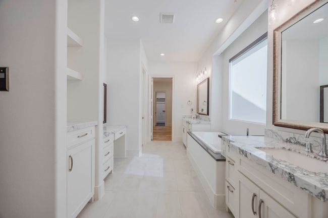 Full bath featuring two vanities, recessed lighting, a bath, and light tile patterned floors | Image 18