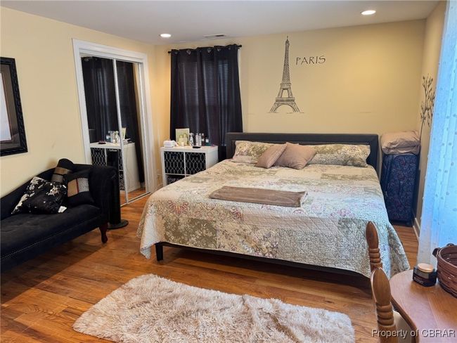 Bedroom with visible vents, wood finished floors, and recessed lighting | Image 13
