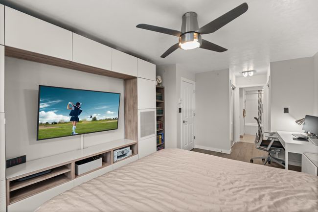 Bedroom with baseboards, wood finished floors, and a ceiling fan | Image 22