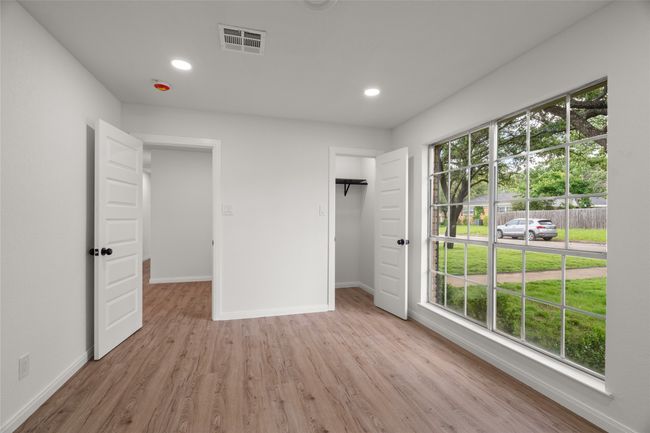 Unfurnished bedroom with baseboards, light wood-type flooring, and recessed lighting | Image 25