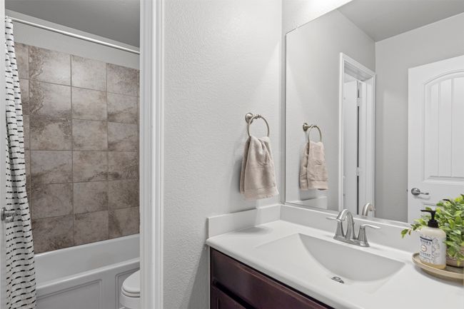 Full bath featuring vanity and shower / tub combo with curtain | Image 7