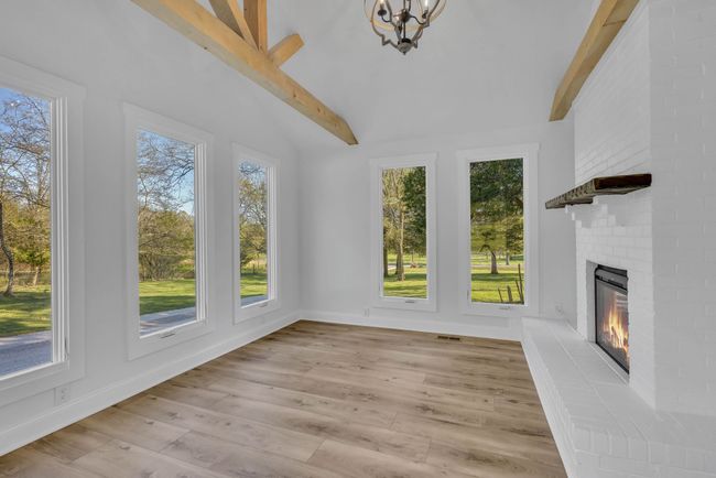 Another view of the sun room with electric fireplace. Lots of natural light in this room. | Image 18