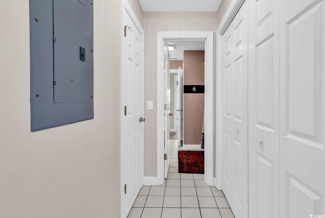 Corridor featuring electric panel, baseboards, and light tile patterned floors | Image 15