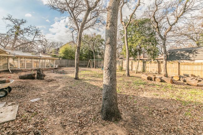 Fenced backyard featuring a playground | Image 24
