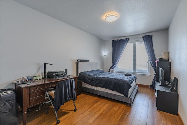 Bedroom featuring a desk and light wood finished floors | Image 17