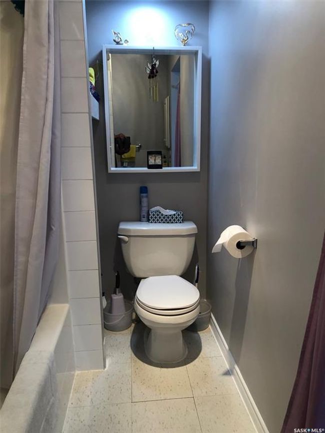 Bathroom featuring baseboards and shower / bathtub combination with curtain | Image 32