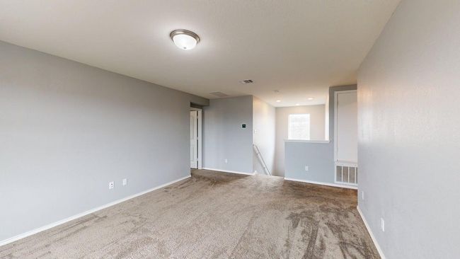 Carpeted spare room featuring baseboards and visible vents | Image 23
