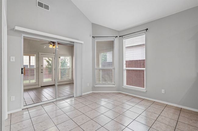 Spare room featuring light tile patterned floors, lofted ceiling, and ceiling fan | Image 26