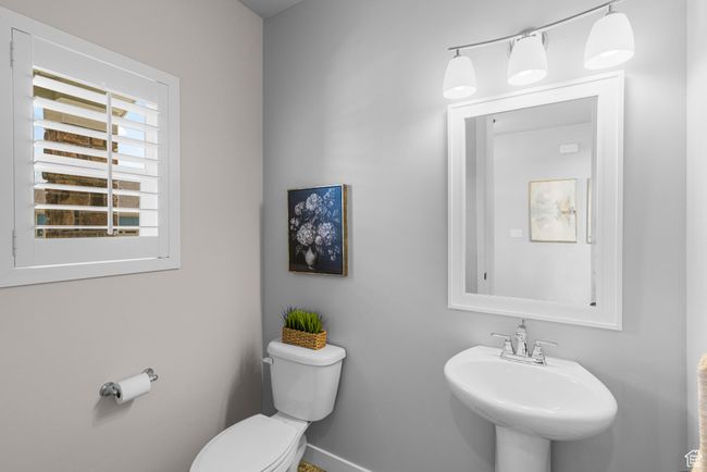 Half bath featuring toilet, baseboards, and a sink | Image 17