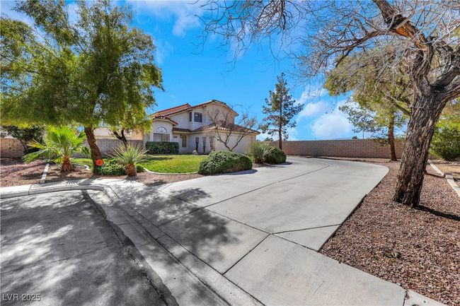 Mediterranean / spanish home with driveway, a tiled roof, fence, a front yard, and stucco siding | Image 44