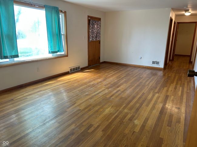 Original hardwood floors are in decent condition. | Image 12