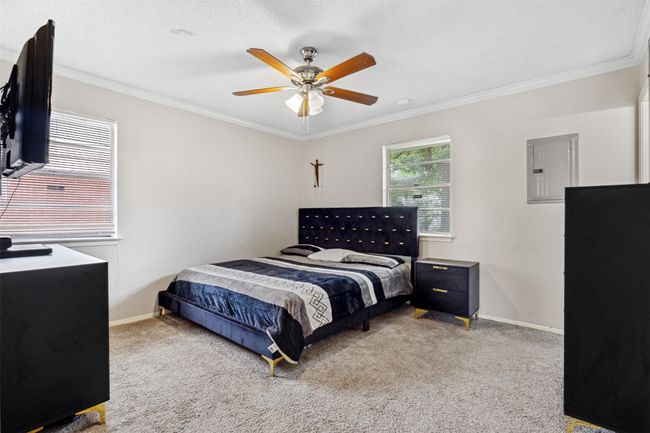 Bedroom featuring ornamental molding, electric panel, and carpet flooring | Image 21