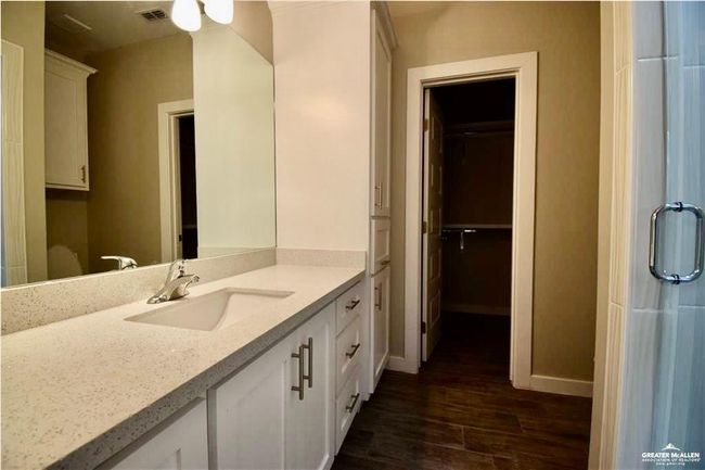 Bathroom featuring wood finished floors, vanity, and a spacious closet | Image 5
