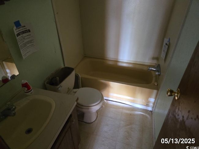 Bathroom with a tub to relax in, toilet, and vanity | Image 30