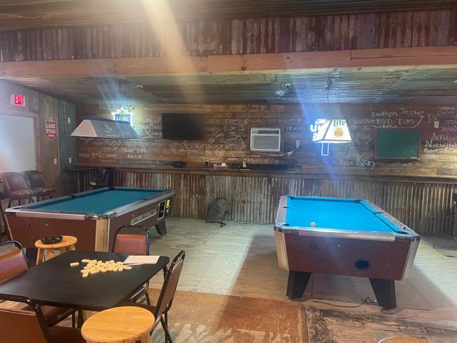 Recreation room with pool table, wooden walls, tile patterned floors, and an AC wall unit | Image 9