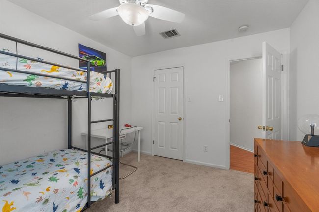 Bedroom featuring light colored carpet and a ceiling fan | Image 23