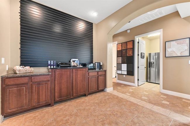 Office space featuring arched walkways, baseboards, an accent wall, and visible vents | Image 10