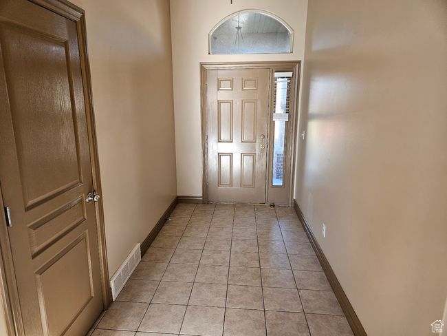 Entrance foyer with light tile patterned flooring, visible vents, and baseboards | Image 4