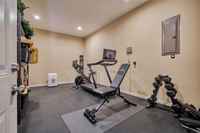 Spacious home gym with padded flooring for a comfortable workout experience. | Image 26