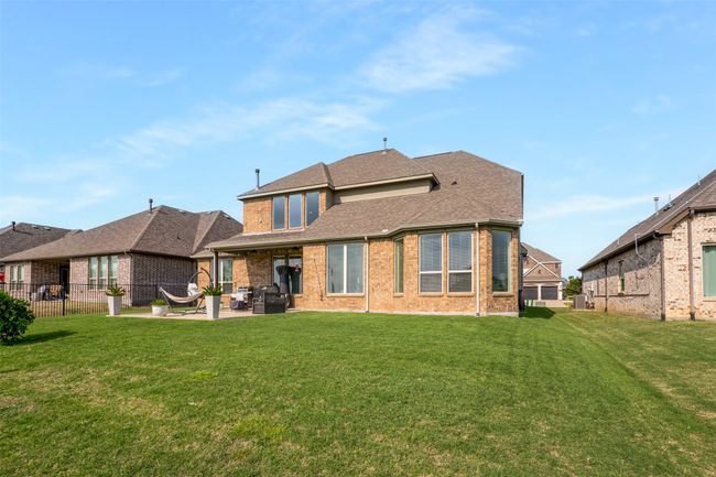 Back of property featuring a lawn, brick siding, and a patio area | Image 36
