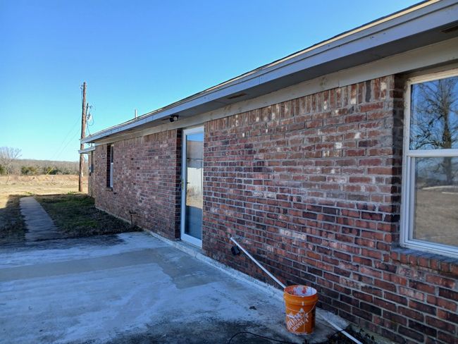 View of home's exterior with a patio | Image 13