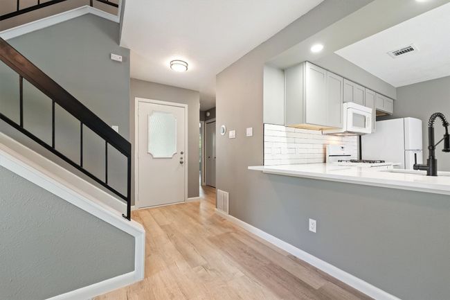 Entrance foyer featuring light wood-style floors, baseboards, and stairs | Image 11