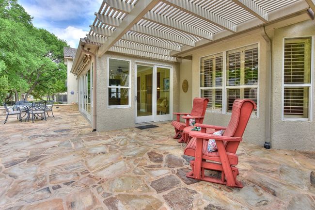 View of pergola seating area toward sliding side door. | Image 27