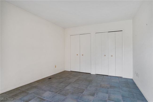Unfurnished bedroom featuring baseboards and multiple closets | Image 33