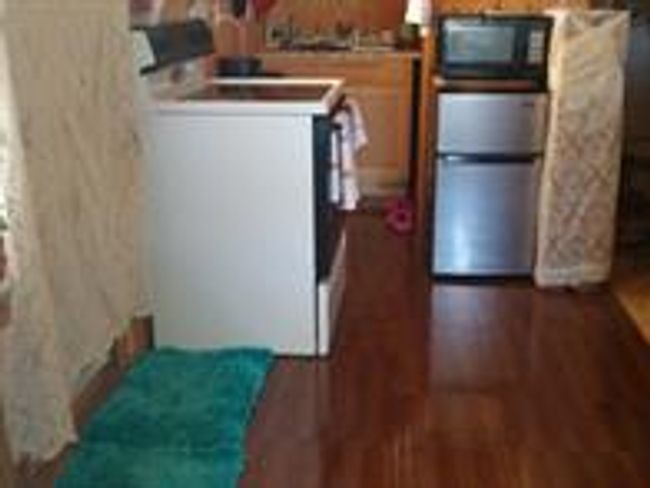 Kitchen featuring white range oven and dark hardwood / wood-style floors | Image 7
