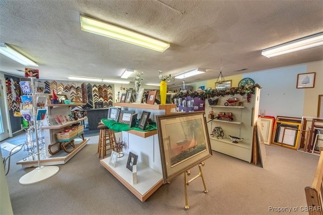 Misc room with a textured ceiling and carpet flooring | Image 8