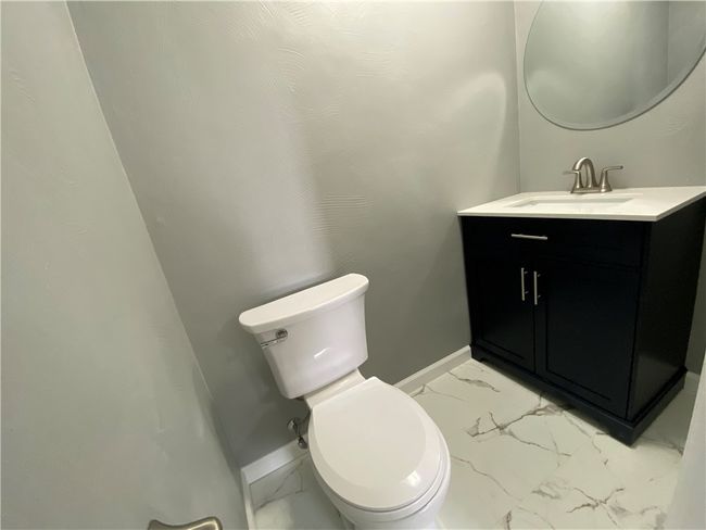 Gorgeous remodeled half bath with new toilet, vanity and flooring. | Image 20