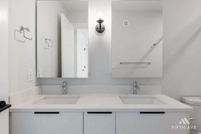 Bathroom featuring toilet and double vanity | Image 24