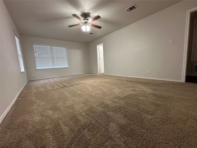 Unfurnished room with a ceiling fan and carpet flooring | Image 32
