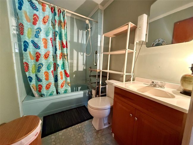 Full bathroom with toilet, vanity, and shower / bath combo with shower curtain | Image 13