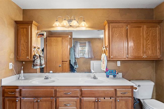 Full bath featuring double vanity, toilet, and a sink | Image 27