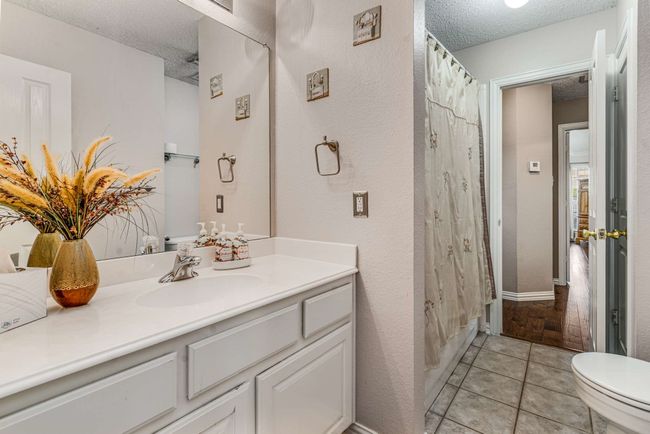 Full Jack and Jill bathroom with a vanity, toilet, and tile patterned flooring | Image 32