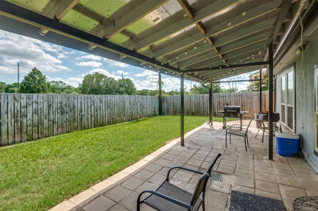 Fenced backyard with a patio area and area for grilling | Image 22