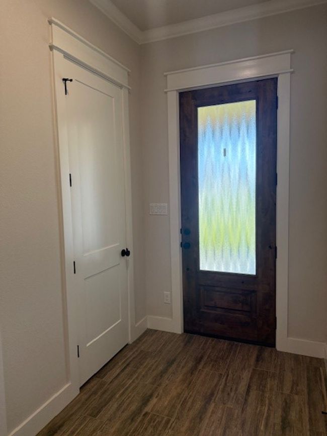 Foyer entrance featuring dark wood-style floors and ornamental molding | Image 5