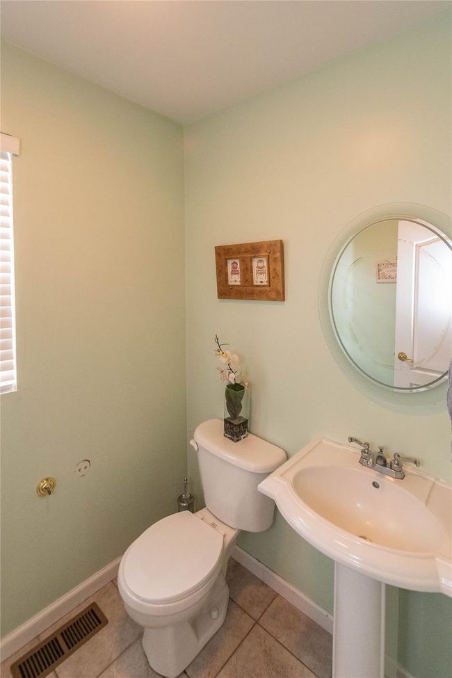 Half bath featuring tile patterned flooring, toilet, baseboards, and visible vents | Image 23