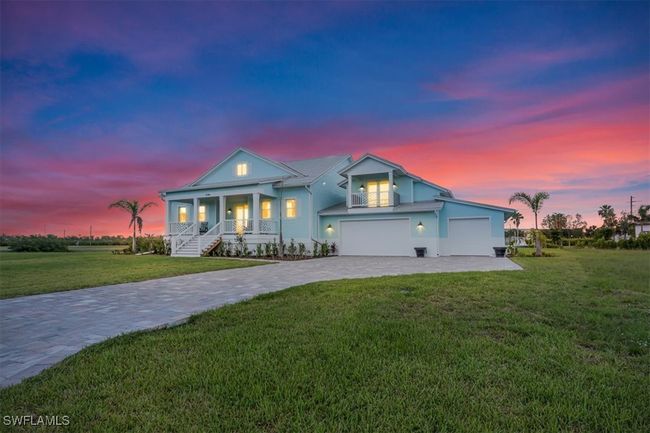 View of front of home featuring covered porch, decorative driveway, and a front yard | Image 36