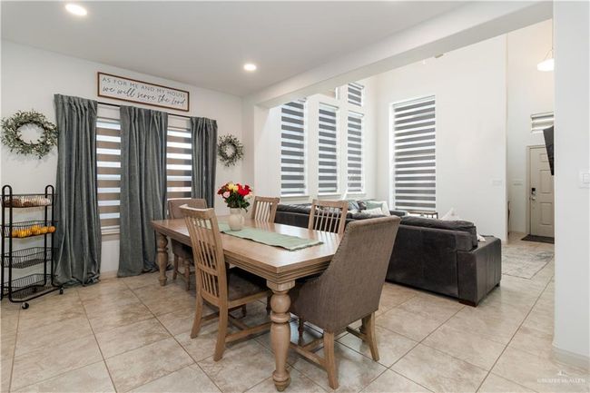 Dining room with recessed lighting and light tile patterned flooring | Image 7